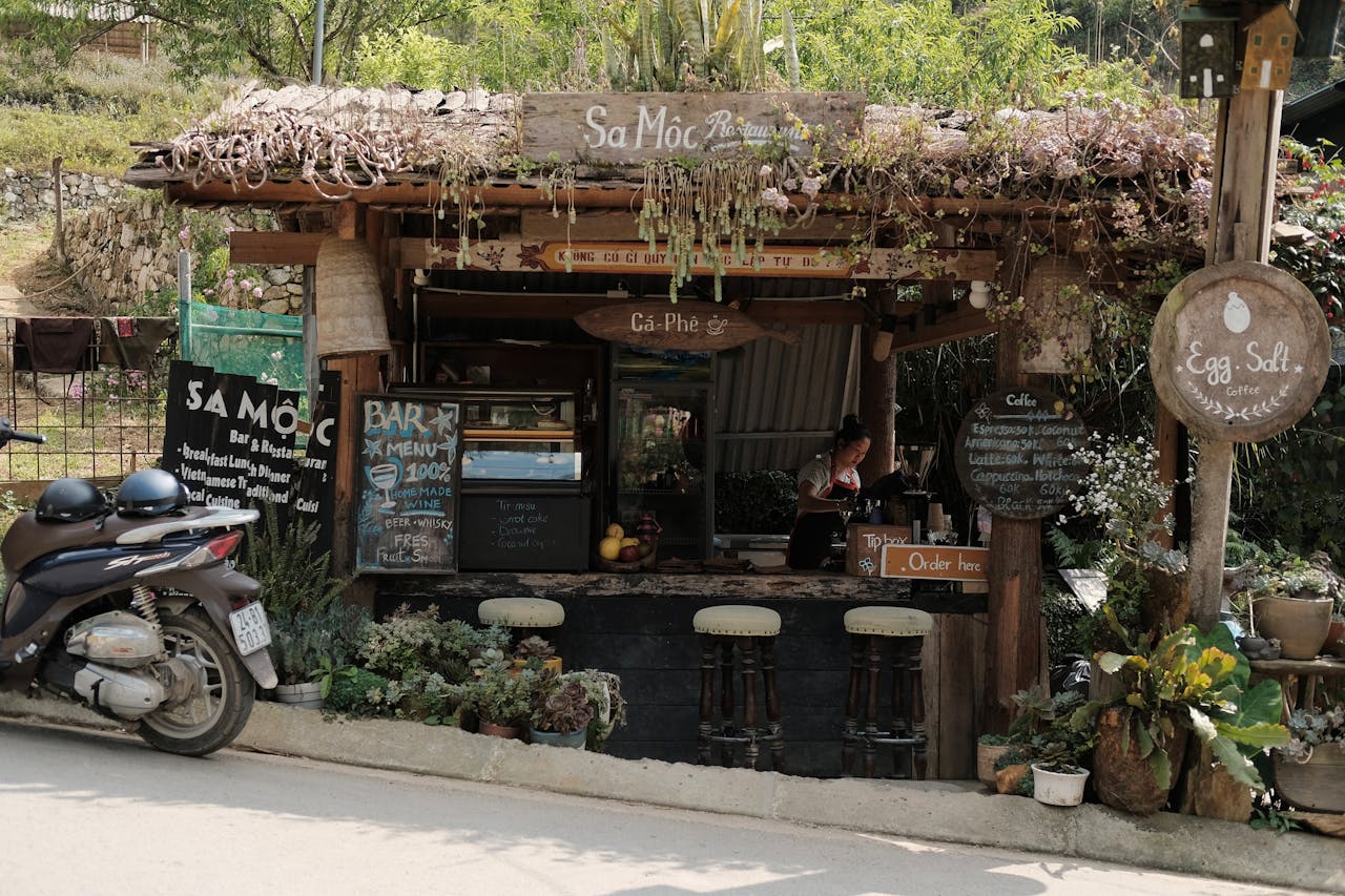 Rustic cafe stall on a sunny day, offering coffee and local delicacies.